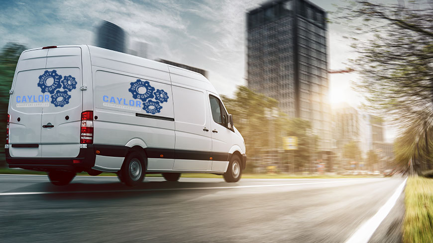 A van with the Caylor Equipment Logo on the side driving down the street