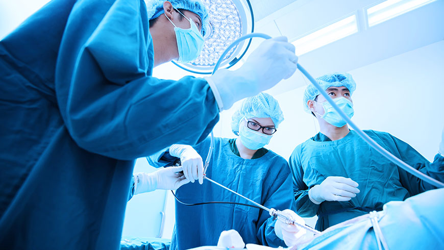 three surgeons in surgery with a rigid endoscope